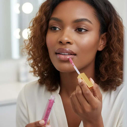 Lip Gloss from Dazzle Me in a clear tube with pink gloss and gold applicator, applied to lips with a wand